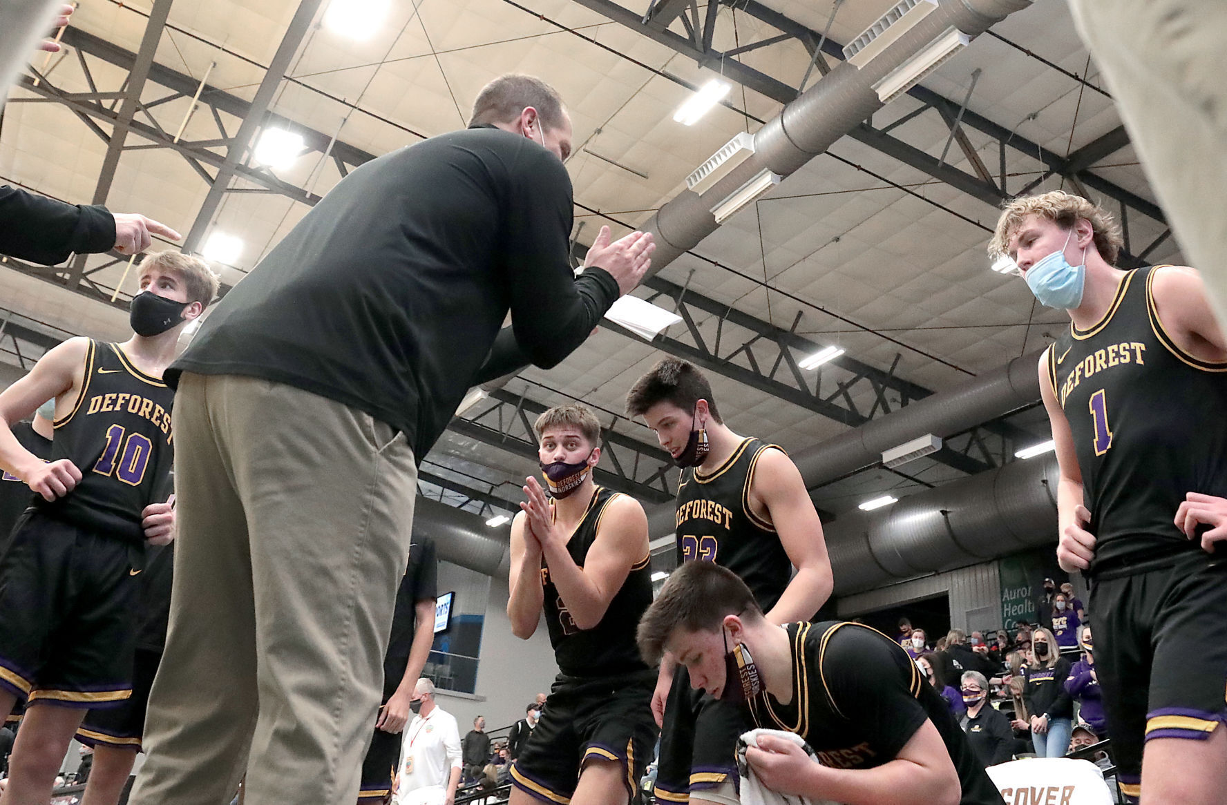 WIAA state boys basketball photo: DeForest coach Craig Weisbrod instructs the Norskies